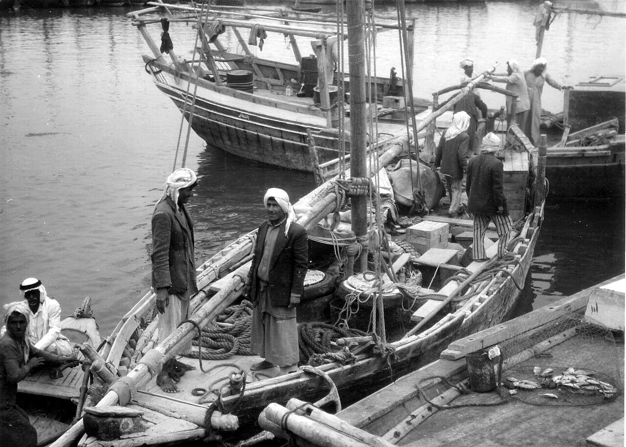 Traditional dhow boats and workers at Kuwait harbour in 1961