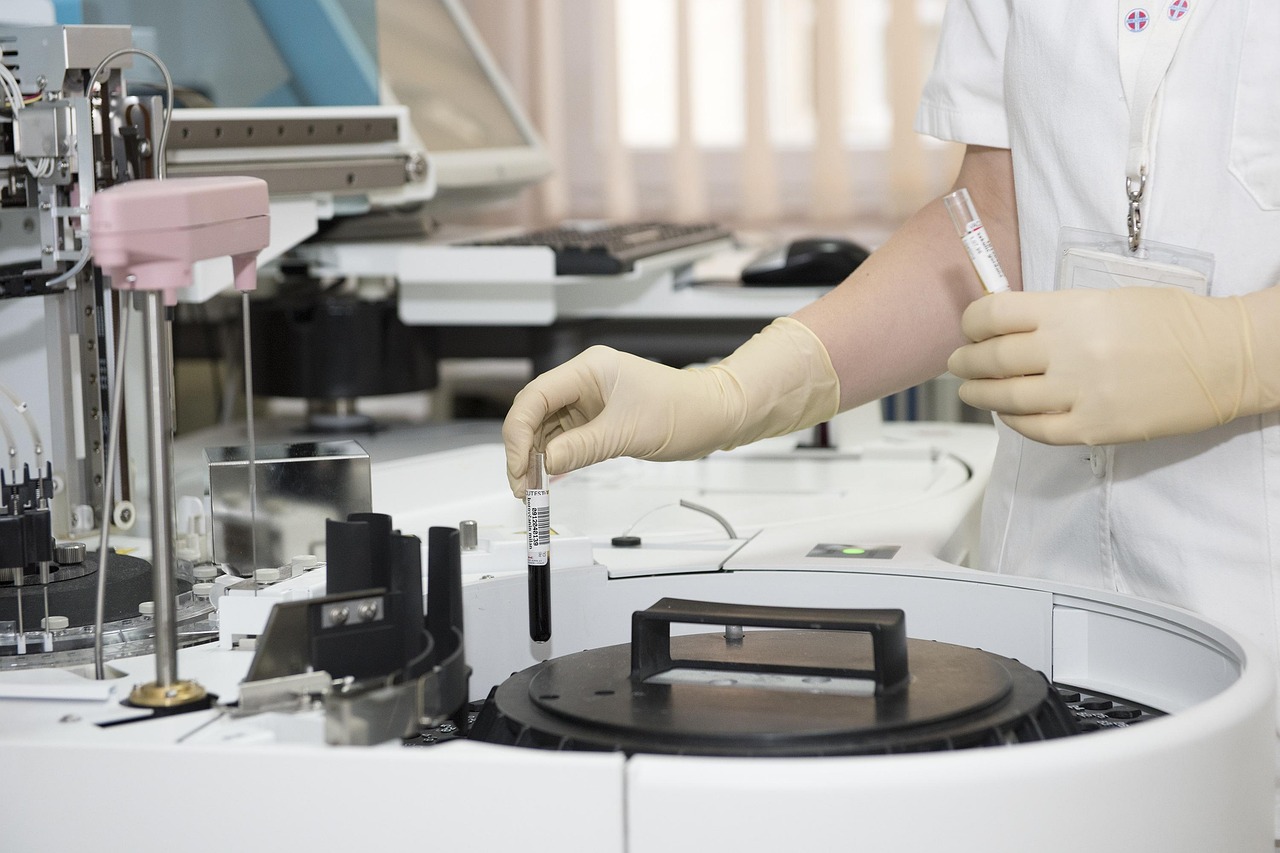 Medical technician operating laboratory equipment