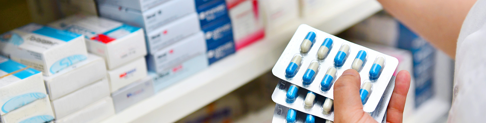 Pharmacist holding capsules